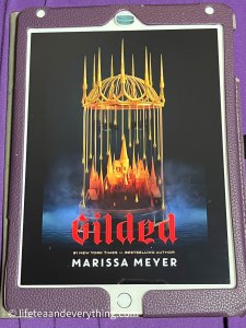 iPad showing cover of book Gilded by Marissa Meyer