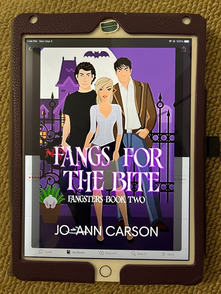 iPad showing cover of Fangs for the Bite by Jo-Ann Carson