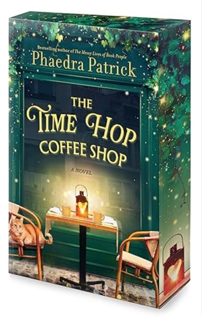 Box showing the cover of The Time Hop Coffee Shop by Phaedra Patrick, showing a small table with two chairs. On the table is a lamp lit by candles, and two cups of coffee. A cat rests on one of the chairs.